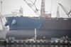 A ship sits under construction in a ship-building yard in Dalian, China, on Tuesday, Jan. 17, 2017. Contrasting fortunes in Dalian illustrate China’s transition toward consumption and services to cut reliance on debt-fueled infrastructure spending and smokestack industries.