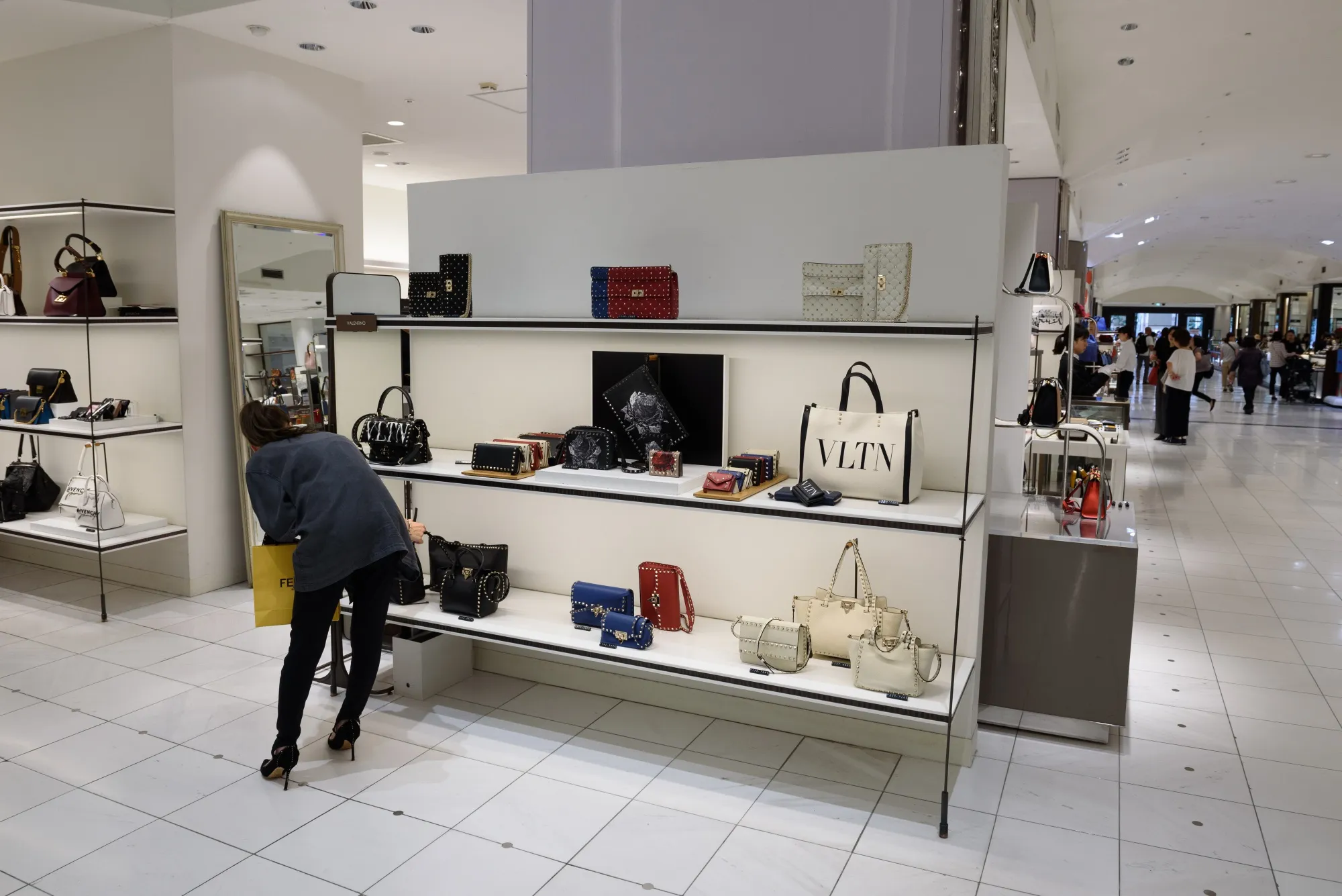 A customer considers a Valentino bag at the Isetan Shinjuku department store&nbsp;in Tokyo.&nbsp;