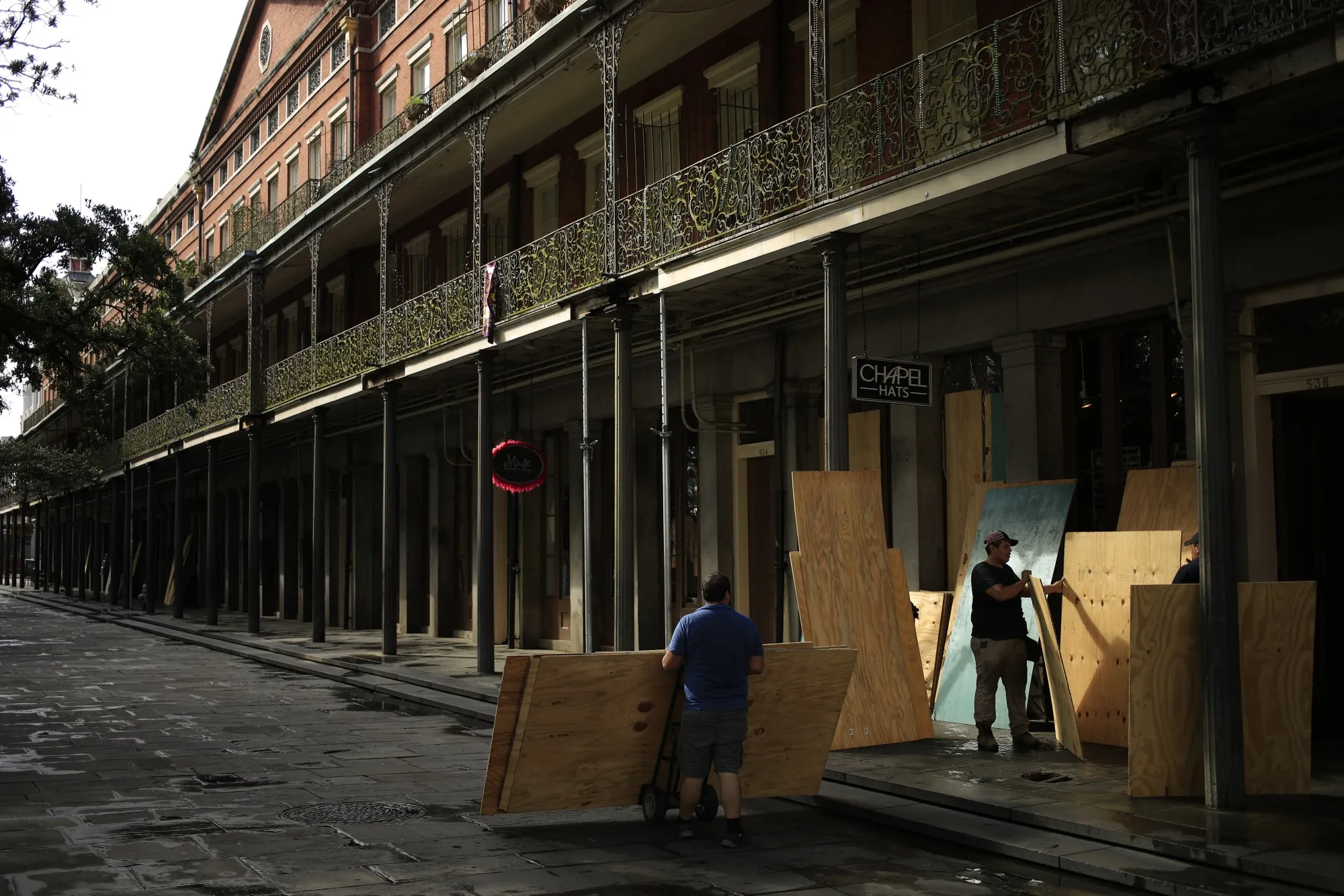 Workers board up shop windows with plywood ahead of Hurricane Ida in the French Quarter neighborhood of New Orleans, Louisiana, on Aug. 28.