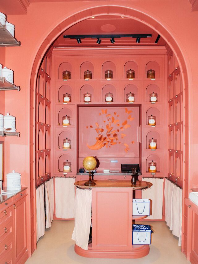 Glass jars line the walls in the salmon-pink colored interior of Antica Cofetteria Romanengo Milano..