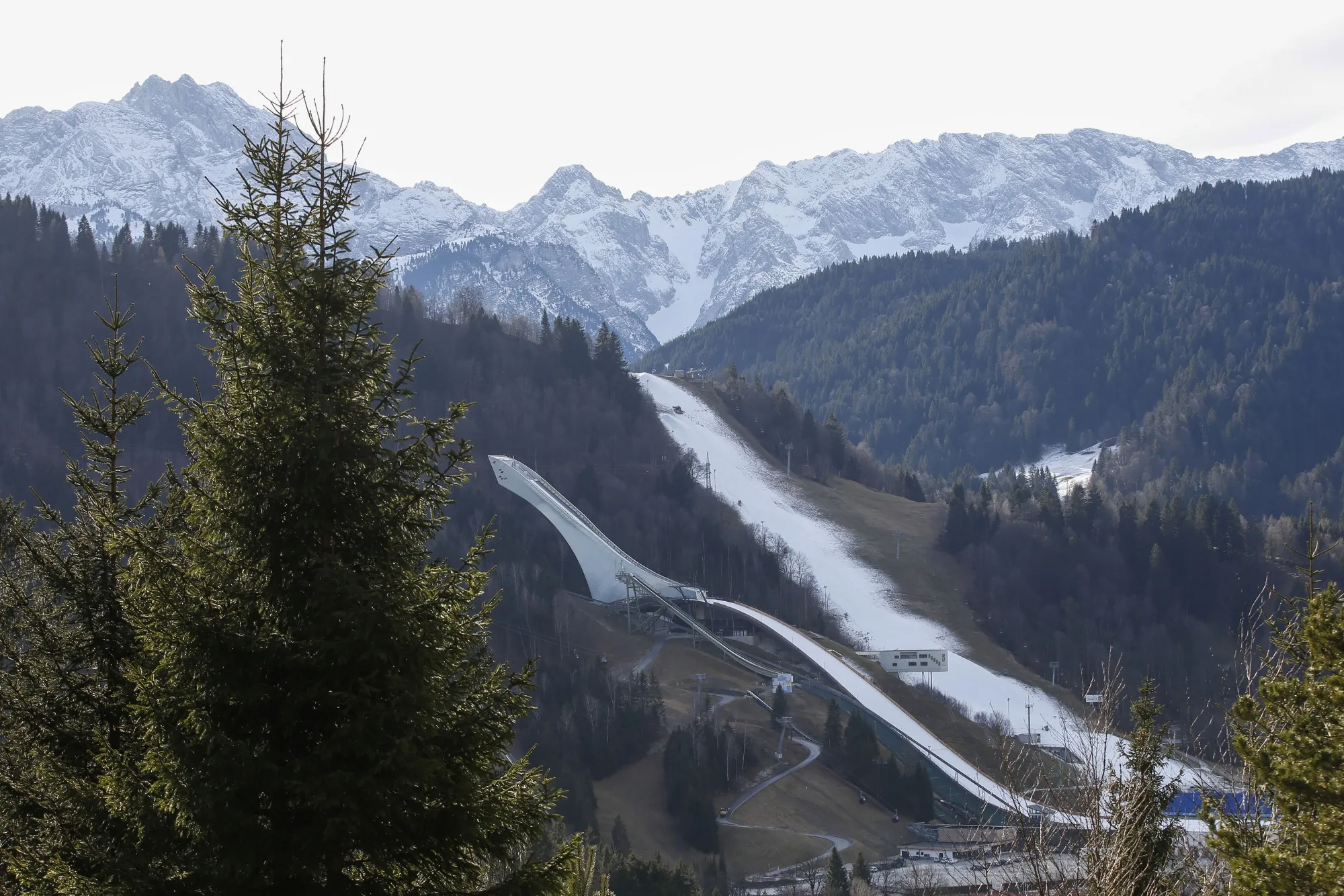 Artificial snow covers the landmark ski jump and the ski slope at the Alpine skiing resort in Garmisch-Partenkirchen, Germany, on Wednesday, Jan. 8, 2020. Like other resorts at relatively low altitude, global warming has left its mark on Garmisch-Partenkirchen — the site of the 1936 Winter Olympics—putting the town’s identity and affluence at risk.