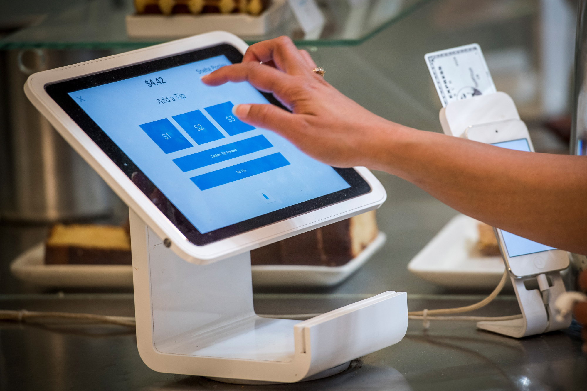 A customer uses a Square&nbsp;device to make a payment.