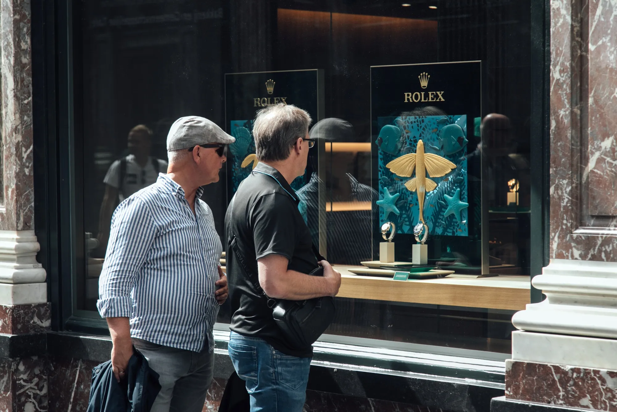 Shoppers browse the window display of a Rolex&nbsp;store in Brussels, Belgium.