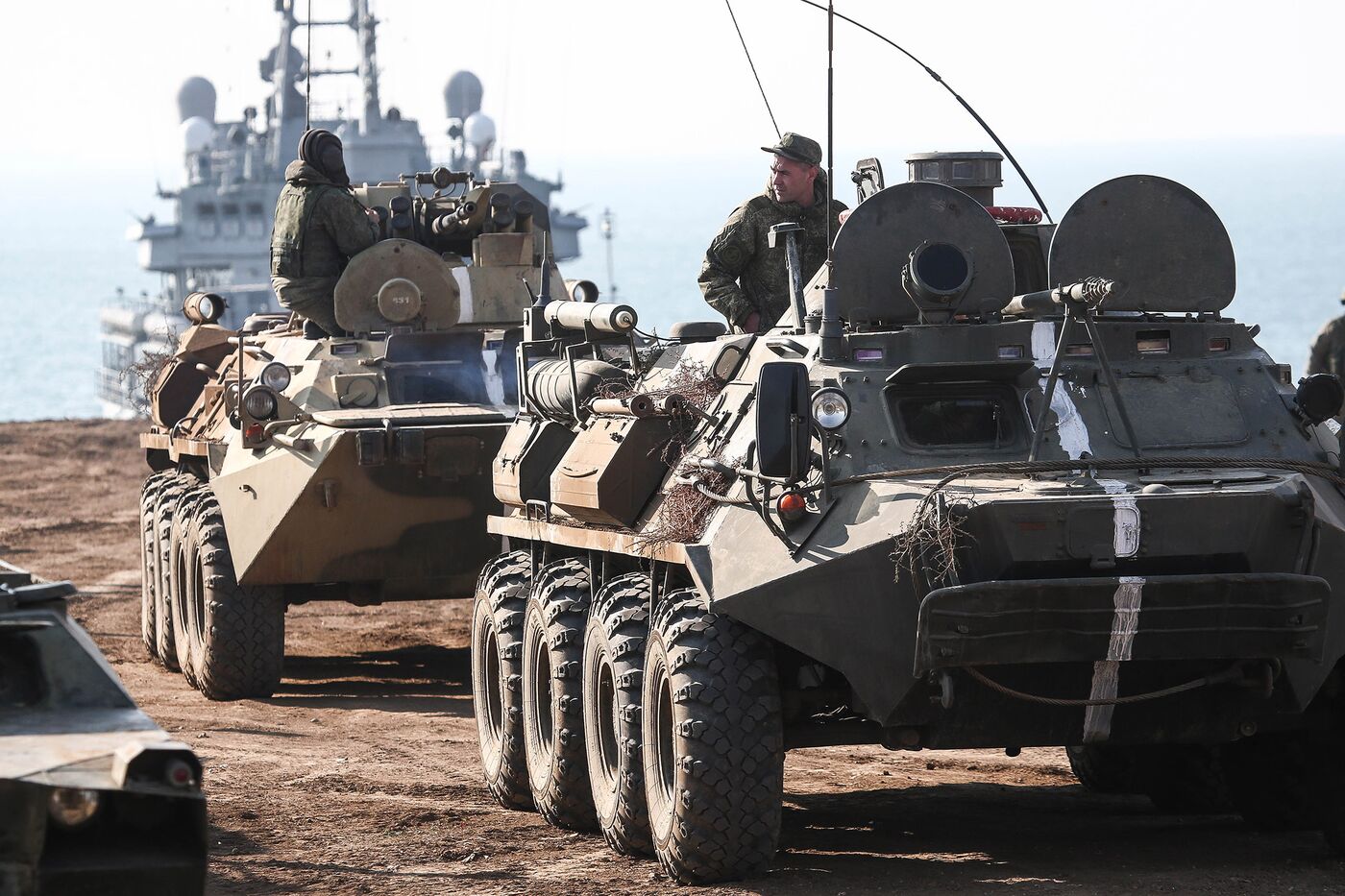 Armored personnel carriers arrive from a landing ship during an amphibious military exercise held by army corps and naval infantry units of the Russian Black Sea Fleet in Crimea on Oct. 18, 2020.