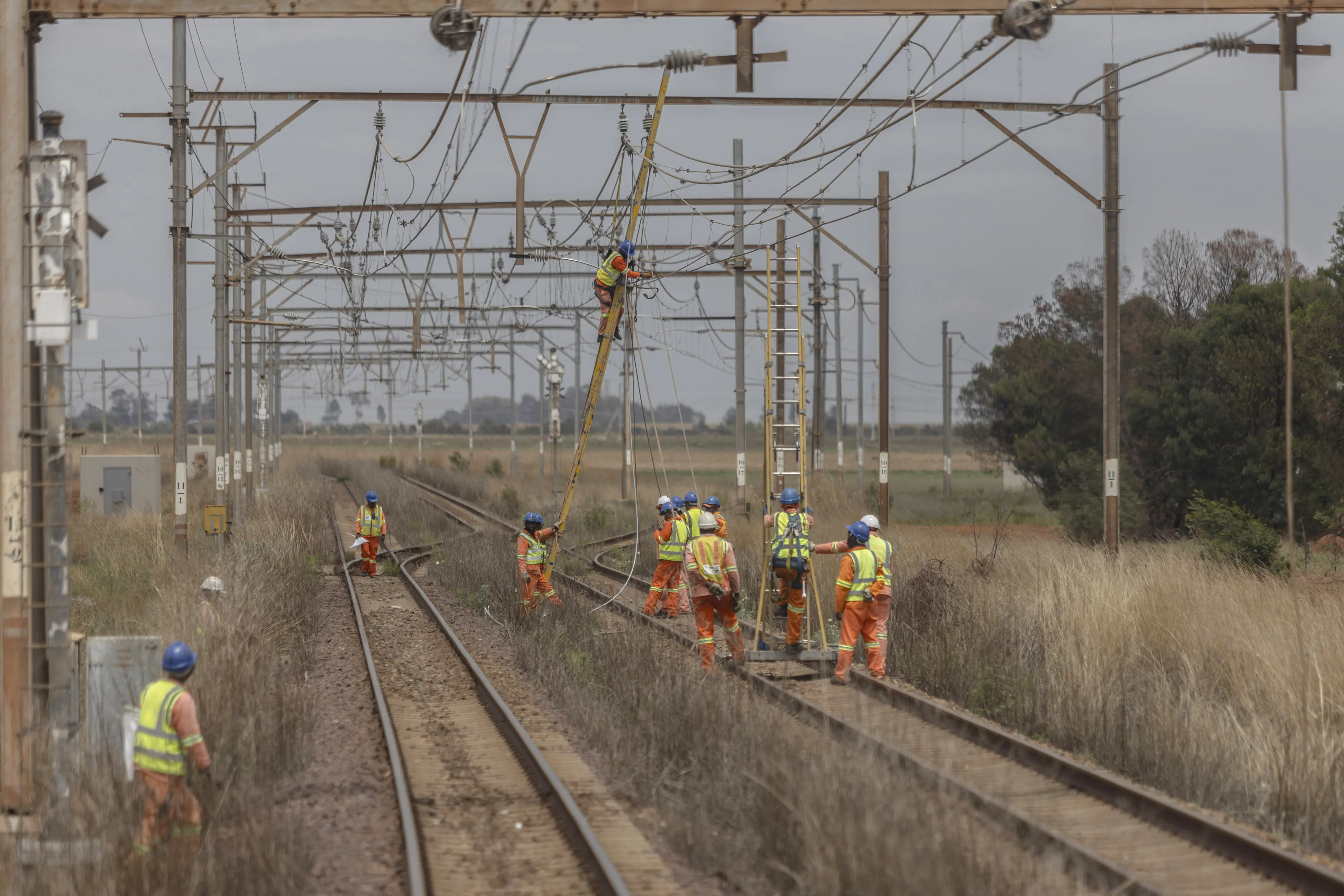 Workers repair sabotaged electrical cables on the central corridor rail freight line in Gauteng, South Africa on Nov. 17.&nbsp;