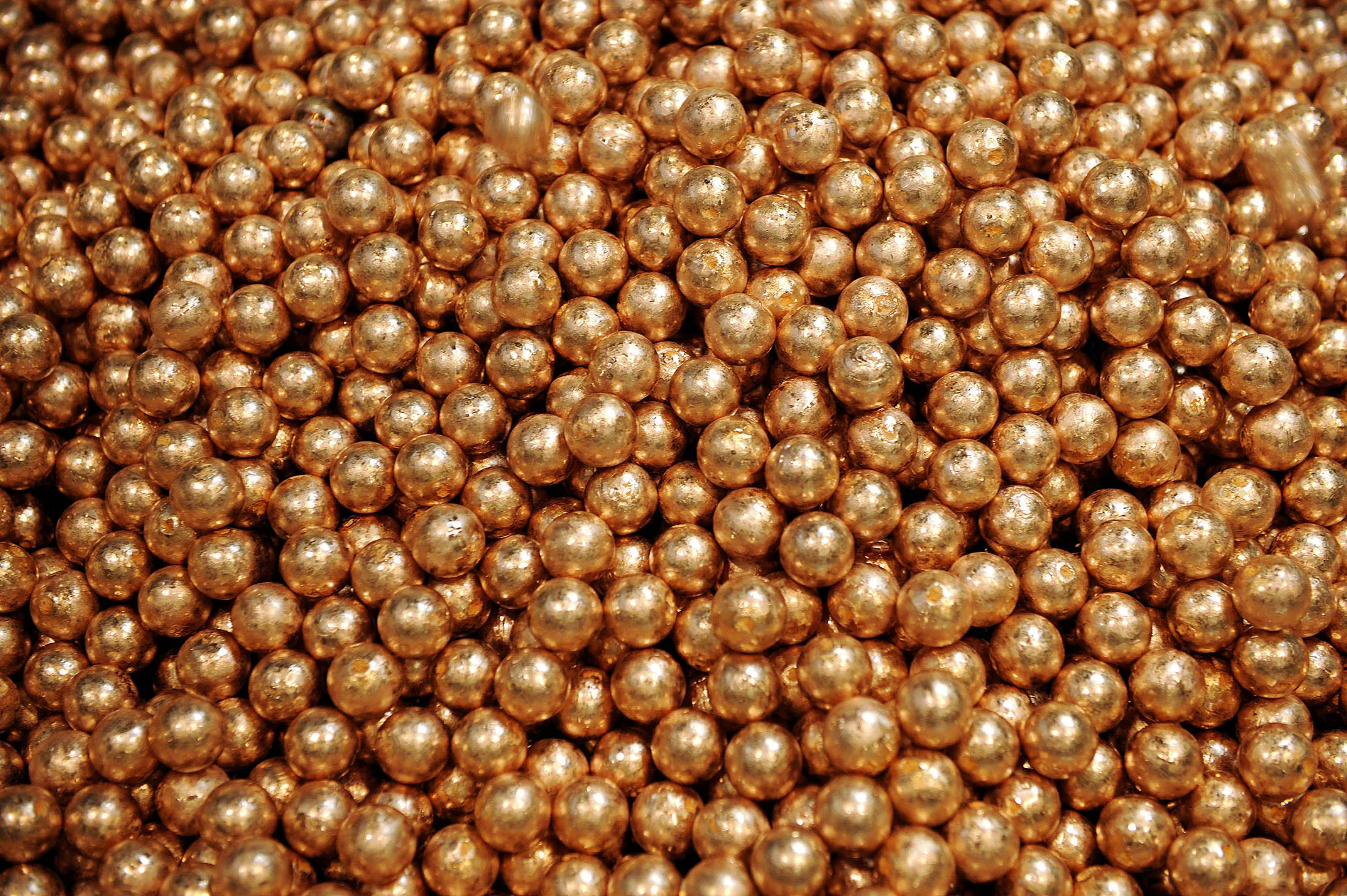 Balls of copper anode sit in a pile at the Luvata Malaysia Bhd. plant in Pasir Gudang, Johor, Malaysia, on Monday, May 13, 2013. At a time when copper stockpiles are rising to the highest in a decade, manufacturers are paying the biggest premiums for the metal in as much as seven years as financing deals lock up supply and extend lines at warehouses.
