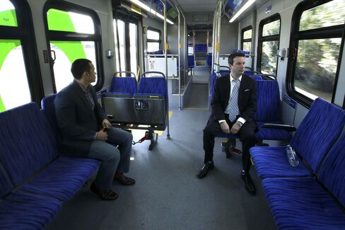 LANCASTER, CA-DECEMBER 24, 2014: Justin Ramirez, left, and James Holtz, fleet sales manager for BYD