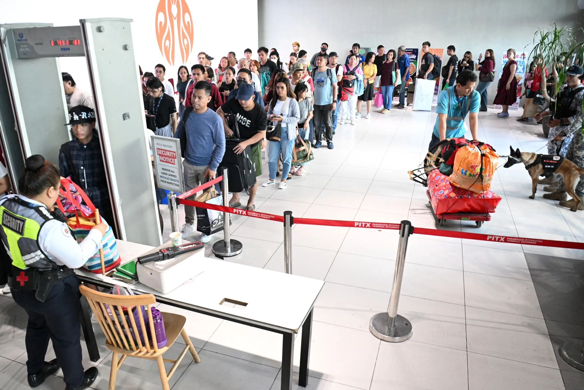 Passengers queue up at a bus terminal in Manila on April 1.