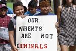 At a protest march following a Spanish Mass at Sacred Heart Catholic Church in Canton, Mississippi, children of mainly Latino immigrant parents hold signs in support of them and others picked up during an immigration raid at a food processing plant in Canton.