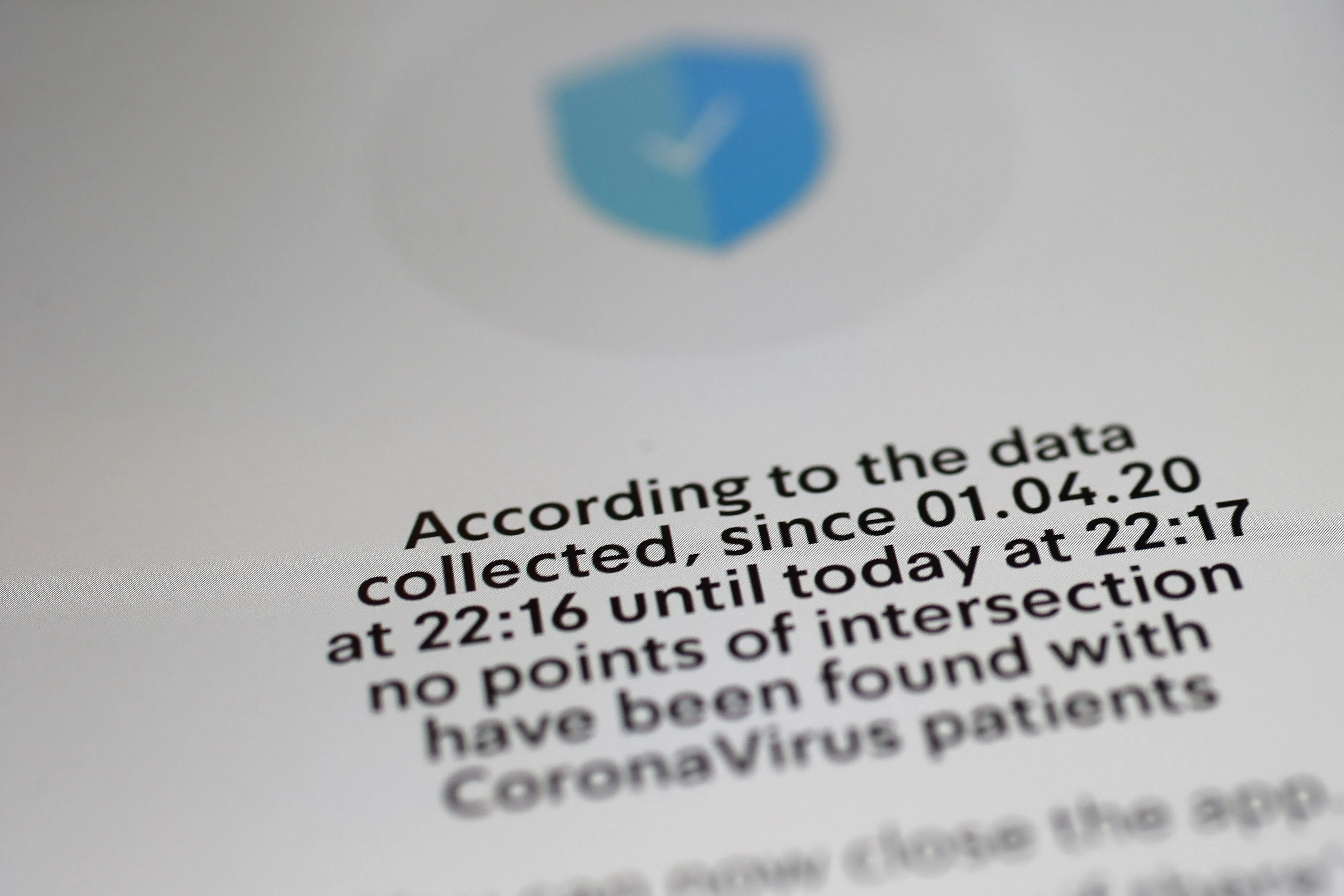 A smartphone screen displays information from the Israel Ministry of Health Hamagen coronavirus symptom tracker app.