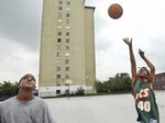 A couple of the last residents of Chicago's infamous Robert Taylor Homes housing project playing basketball in 2006.
