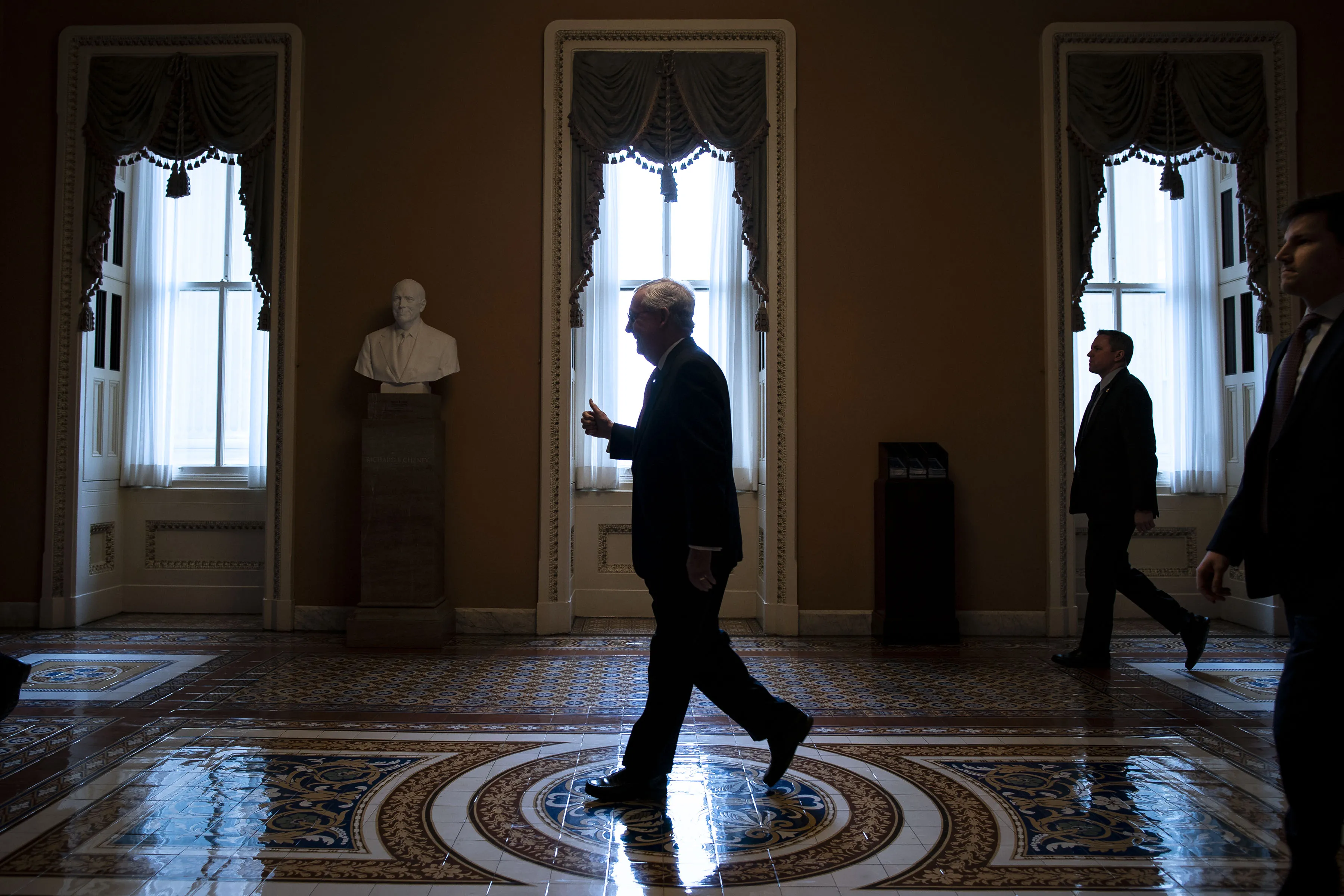Senate Majority Leader Mitch McConnell gives a thumbs up as he returns to his office after his opening remarks at the U.S. Capitol in Washington, D.C., U.S., on Wednesday, March 25, 2020. McConnell said “the Senate is going to stand together and pass this historic relief package today.”