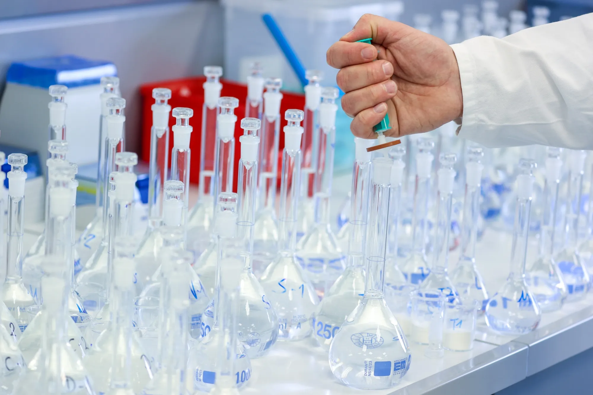 A laboratory worker filtrates liquid with pills during quality control testing at the Stada Arzneimittel AG factory in Bad Vilbel, Germany.