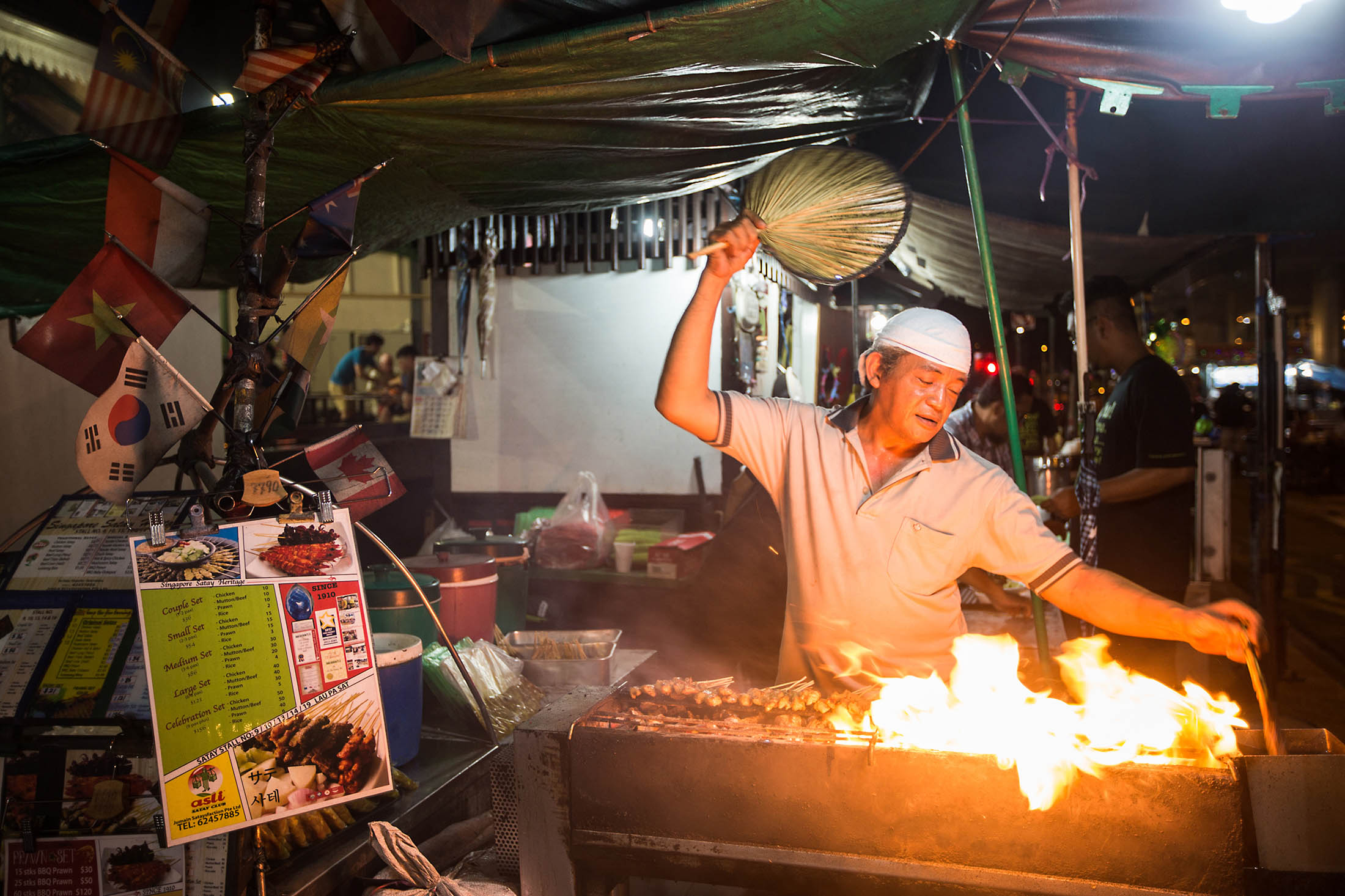 A vendor barbecues satay at the Lau Pa Sat food court in Singapore.
