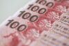 Hong Kong one-hundred dollar banknotes are arranged for a photograph in Hong Kong, China, on Wednesday, Jan. 20, 2016. Hong Kong dollar forwards sank to their weakest level this century, interbank loan rates jumped the most in seven years and the Hang Seng Index tumbled as China's market turmoil fueled speculation the city's 32-year-old currency peg will end.