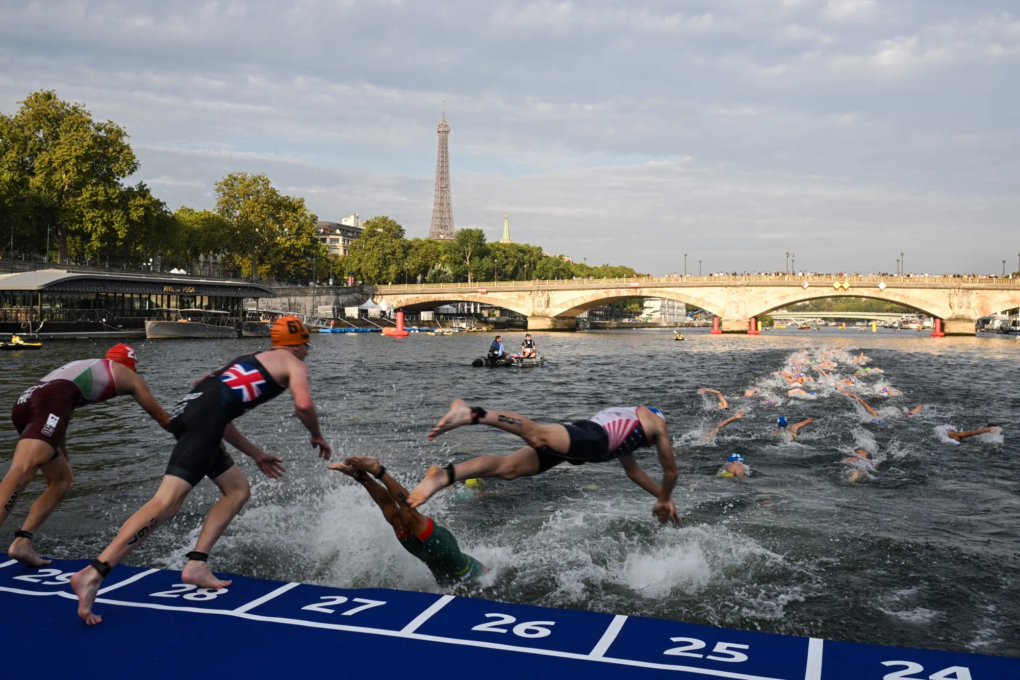 Triathlon athletes dive in the Seine river during an Olympic Games Test Event in Paris on August 18.