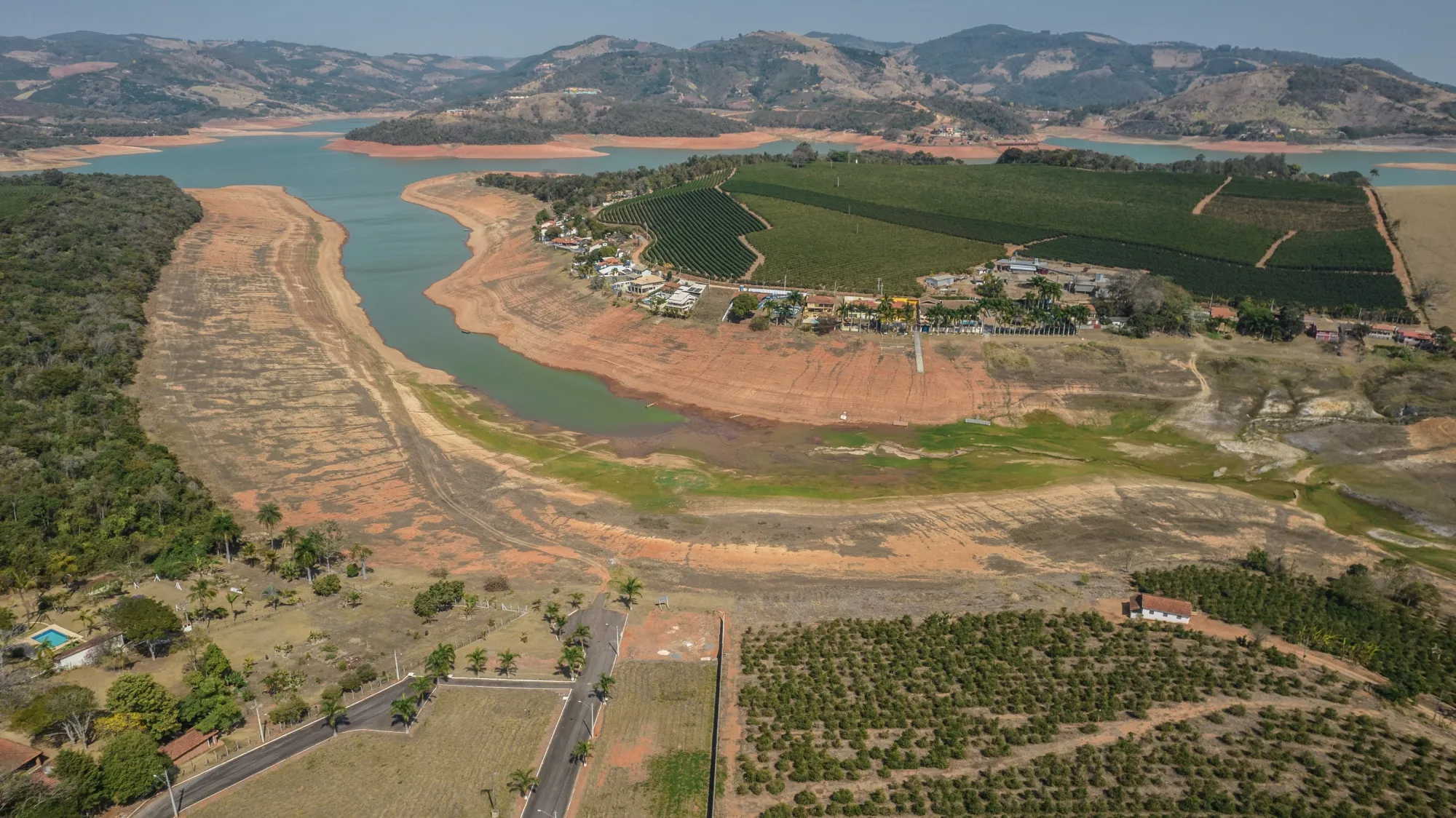 Dry land surrounds farmland along the Pardo River during a drought in Caconde, Sao Paulo state, Brazil, on Aug. 24.