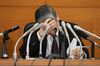 Haruhiko Kuroda, governor of the Bank of Japan (BOJ), looks down at his notes during a news conference at the central bank's headquarters in Tokyo, Japan, on Friday, Jan. 29, 2016. Kuroda sprung another surprise on investors by adopting a negative interest-rate strategy to spur banks to lend in the face of a weakening economy.
