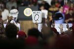 An attendee holds up a QAnon sign&nbsp;before the start of a rally with Donald Trump in Lewis Center, Ohio in 2018.