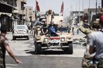 People flee the Old City of Mosul following advances made by Iraqi forces on June 23.
