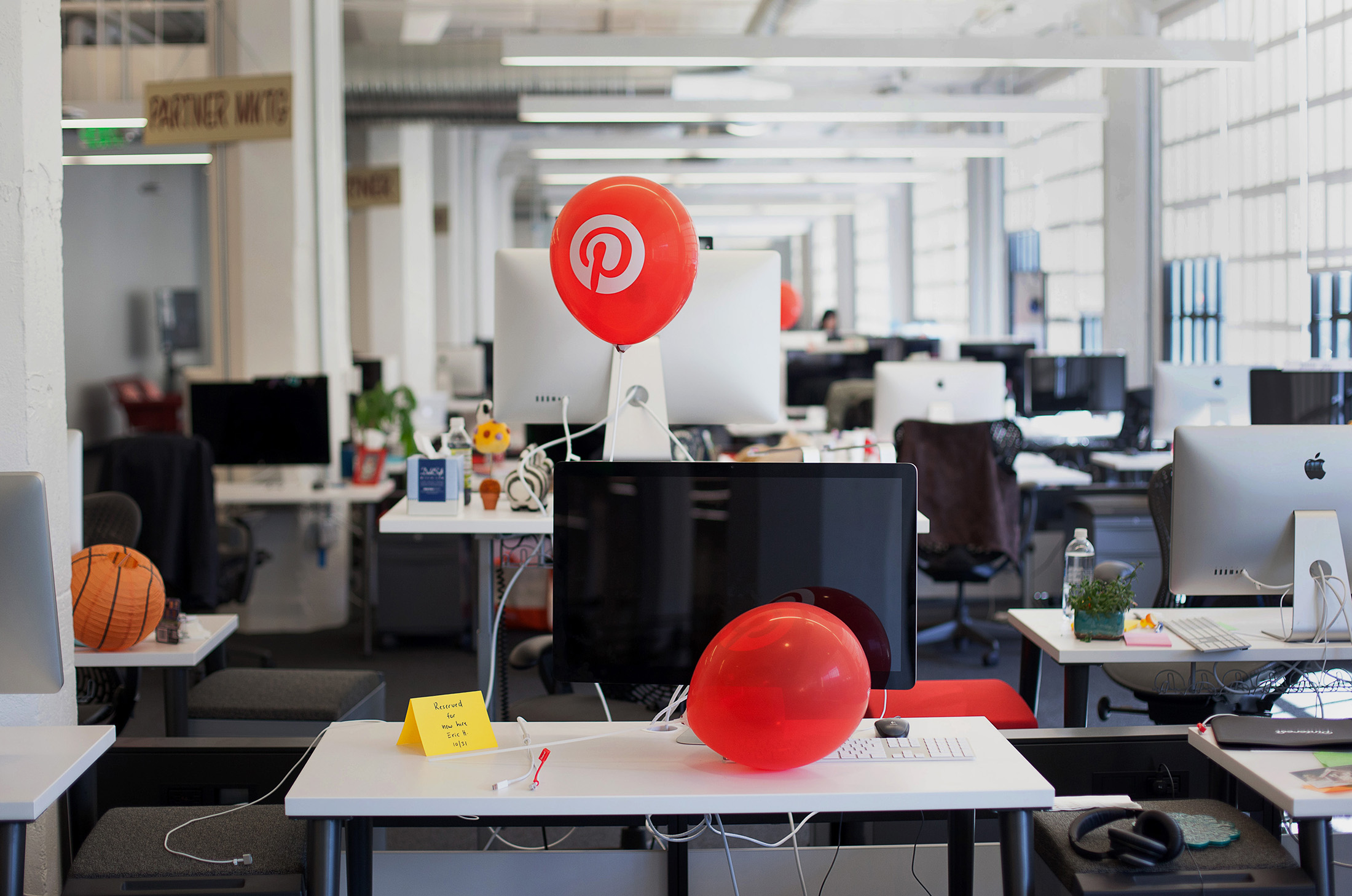 The Pinterest Inc. logo is seen on a balloon displayed to welcome new hires at the company's second office space, located near headquarters, in San Francisco, California, U.S., on Monday, Nov. 3, 2014. Pinterest Inc. is trying to teach businesses how to better use its online scrapbooking site, as the company takes steps to generate more revenue to justify its $5 billion valuation. The San Francisco-based company unveiled a set of free tools that marketers can use to determine which of their posts are working on Pinterest.
