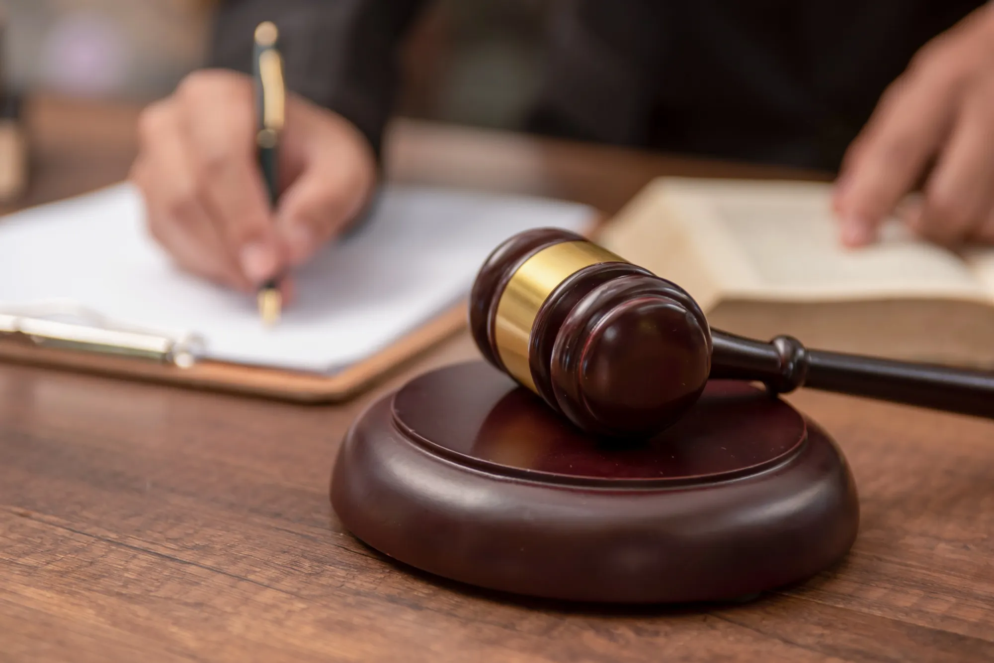 Male lawyer working with contract papers and wooden gavel on tabel in courtroom. justice and law ,attorney, court judge, concept.