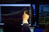 A trader points to monitor displaying an S&P 500 Index (SPX) chart on the floor of the New York Stock Exchange (NYSE) in New York, U.S., on Friday, Feb. 16, 2018. U.S. equities headed for the best week in six years as the rebound in global equities pushed into a sixth day. The dollar strengthened after a five-day selloff and Treasuries climbed.