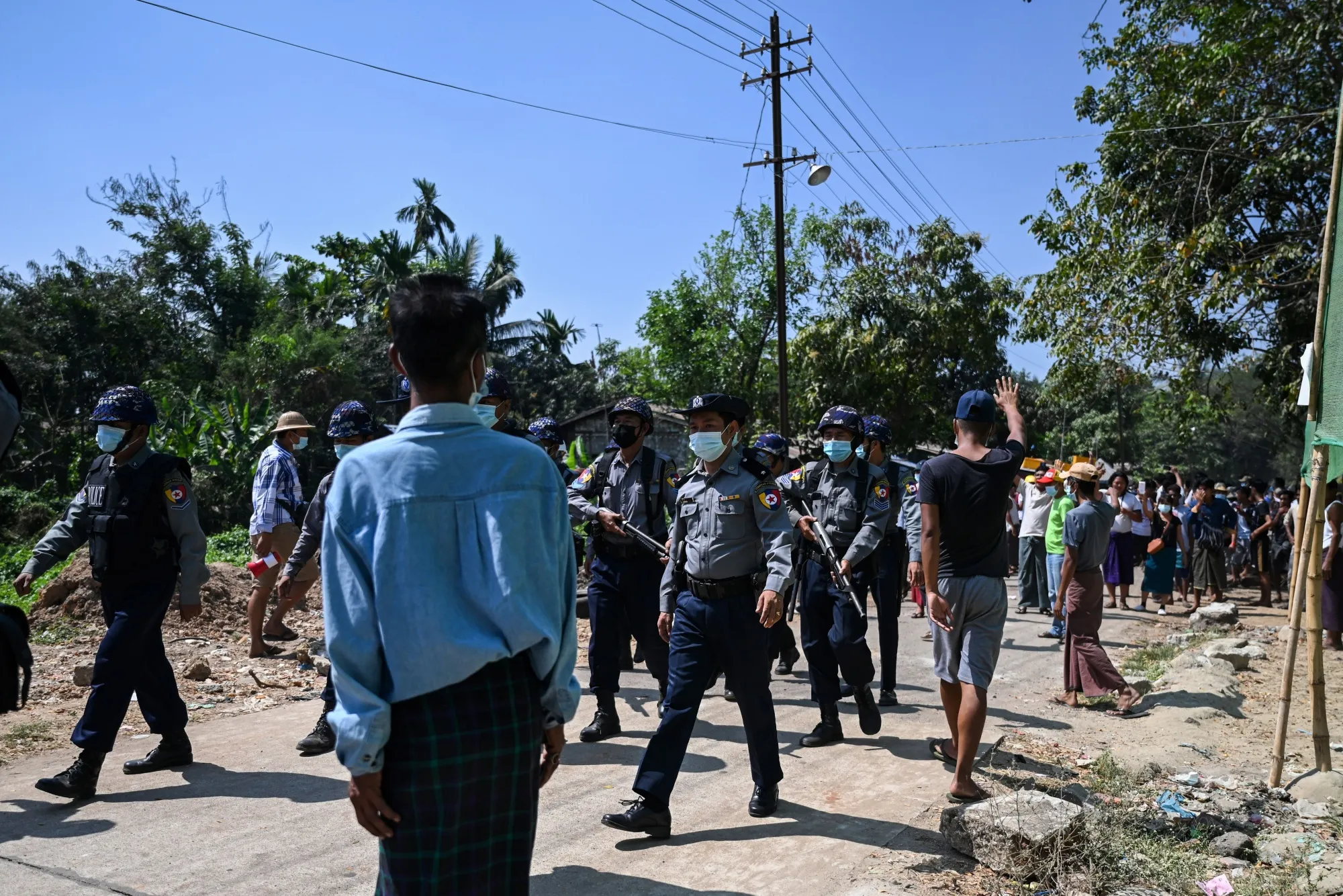 Police leave a neighborhood after being pushed out by residents&nbsp;in Yangon on Feb. 14.