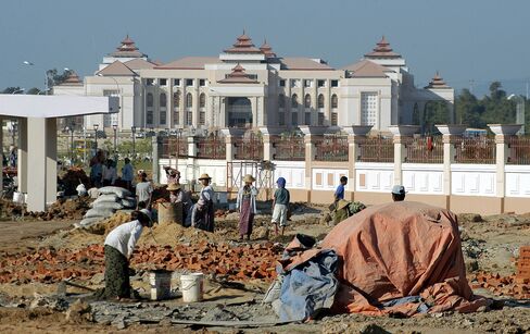 Myanmar laborers work at the construction site of City Hall in the new administrative capital of Naypyidaw.