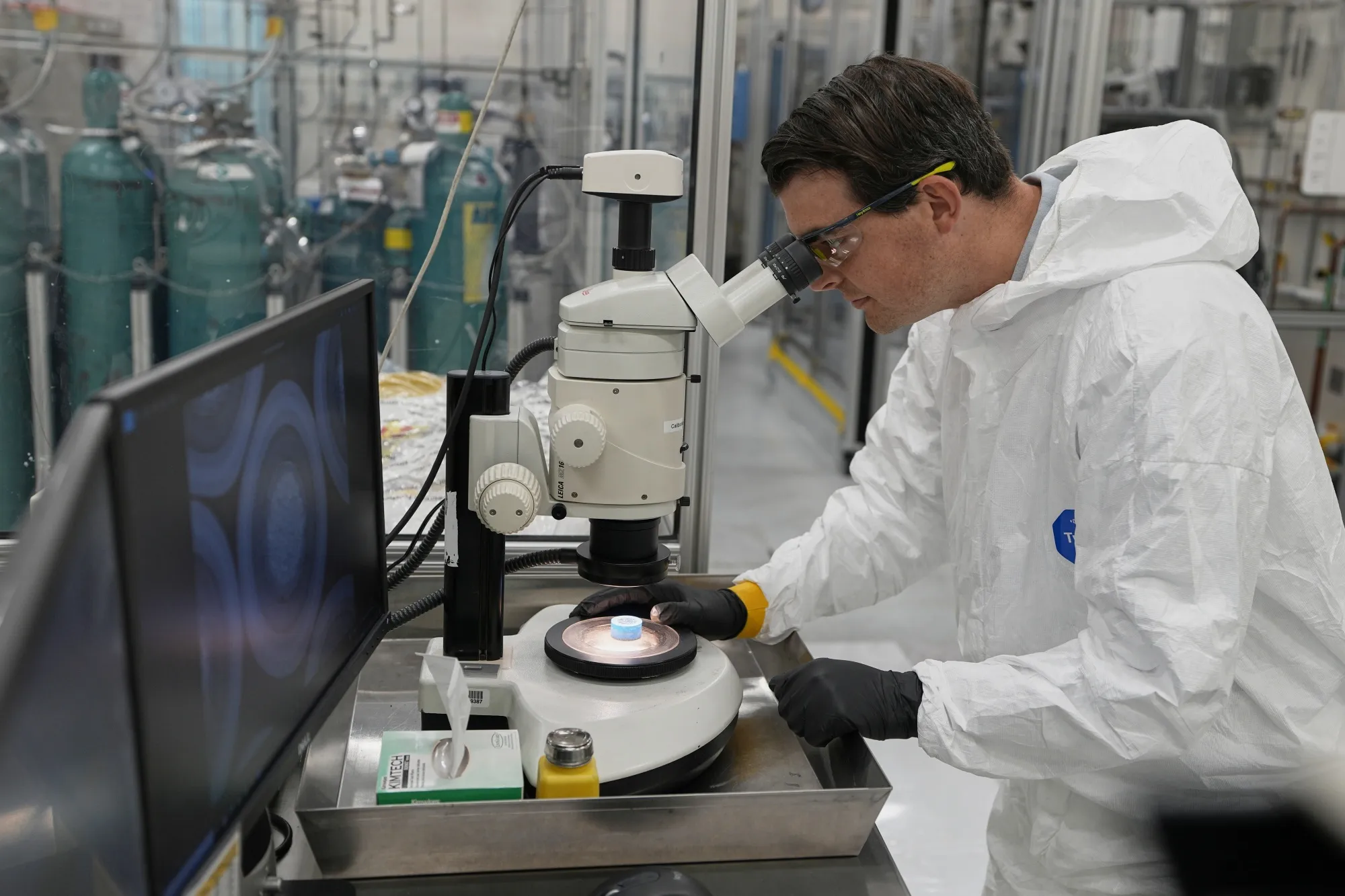 An R&D scientist at X-Energy looks at a sample of Triso fuel in Oak Ridge, Tennessee.