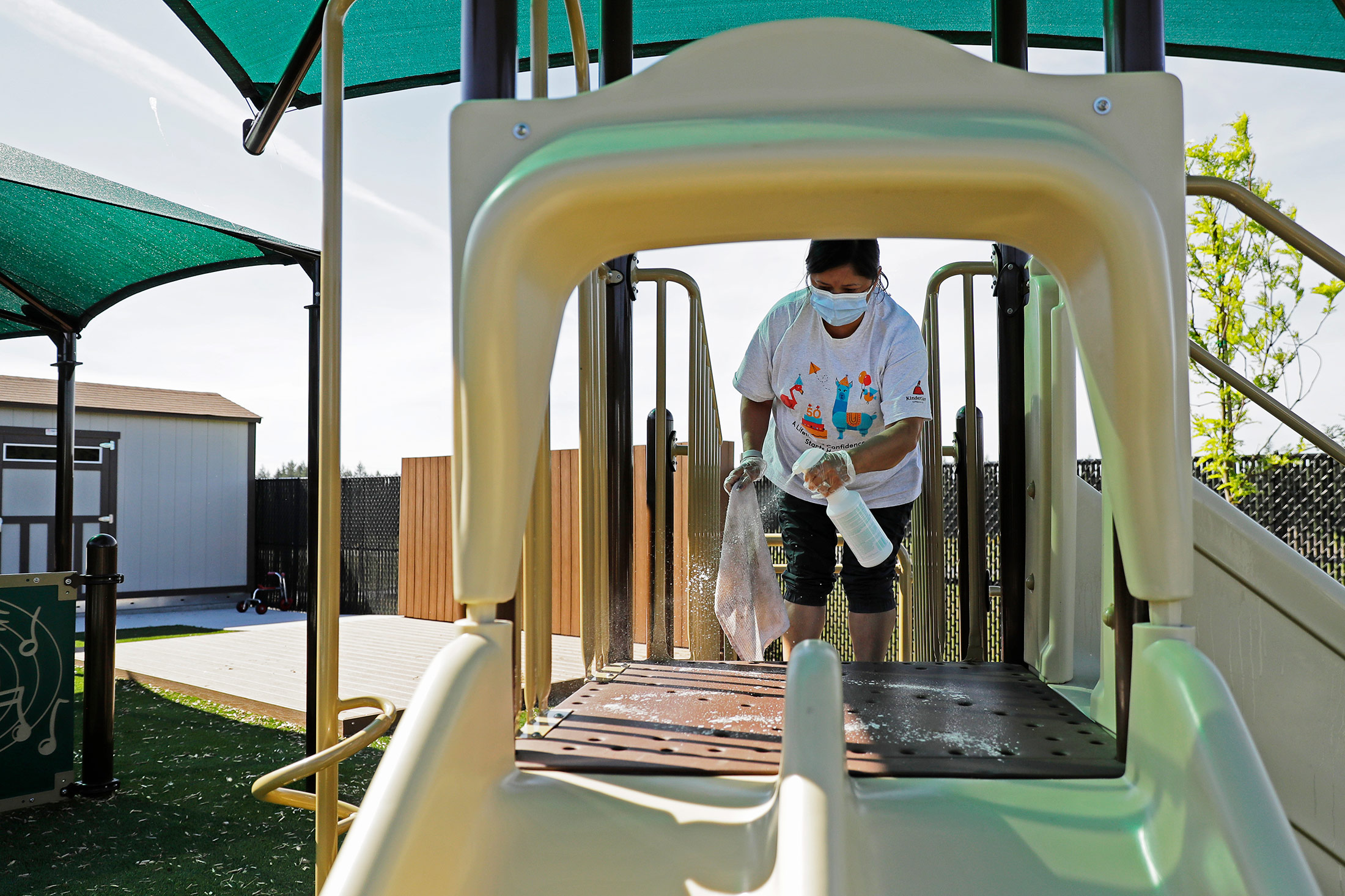 A&nbsp;worker cleans playground equipment at a daycare center in Tacoma, Washington, on May 27.&nbsp;