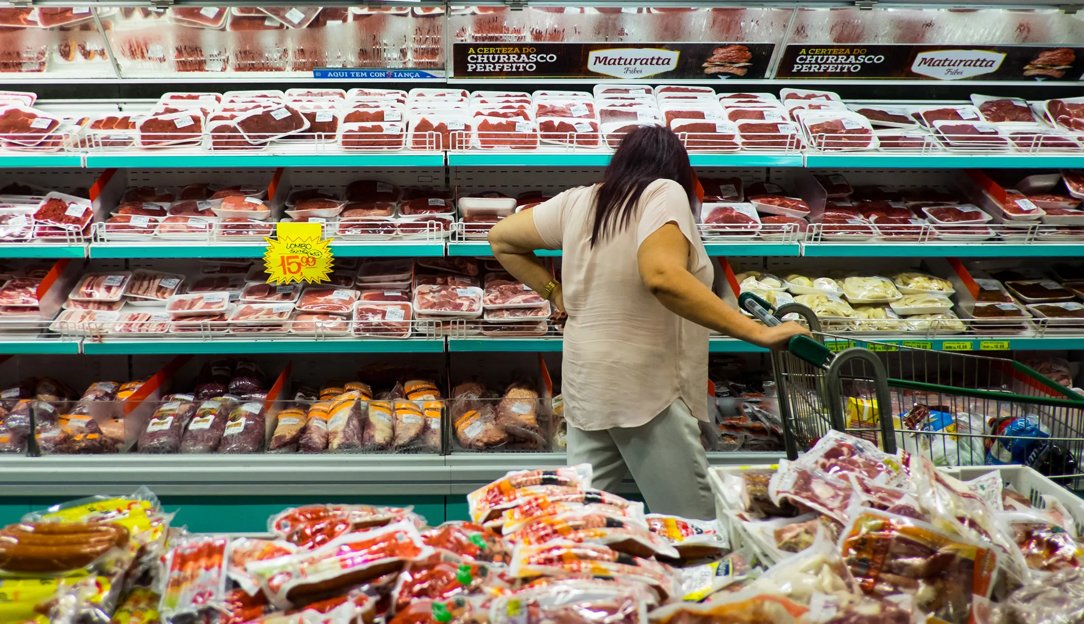 A customer shops for meat in a supermarket in Sao Paulo, Brazil, on Friday, March 17, 2017.
