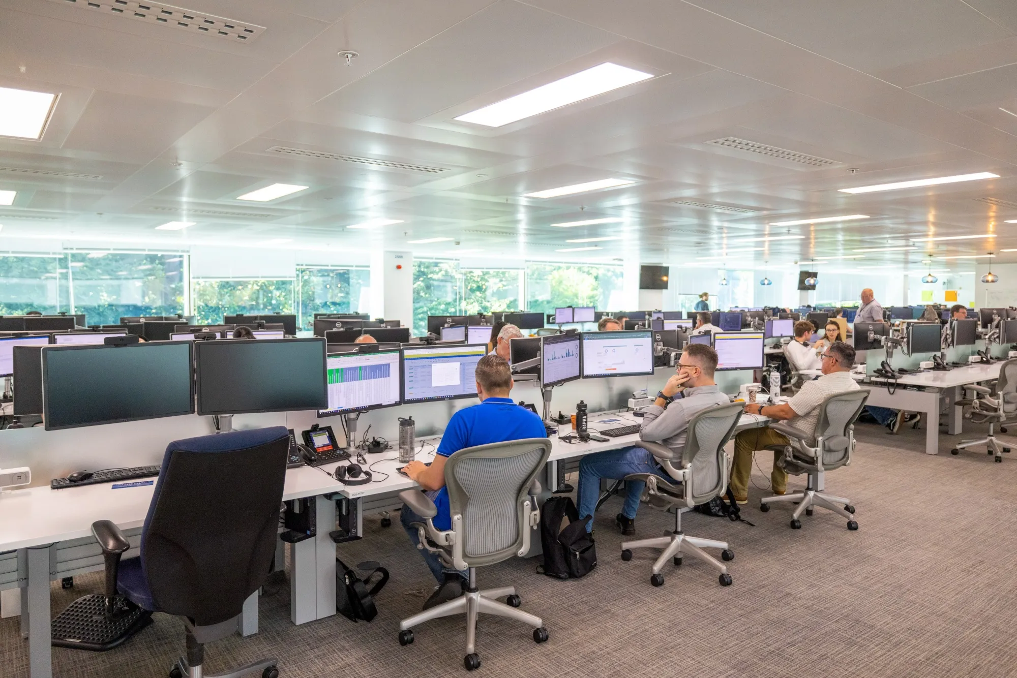 Employees work at computers at the JPMorgan Chase &amp; Co. offices in Bournemouth, UK.