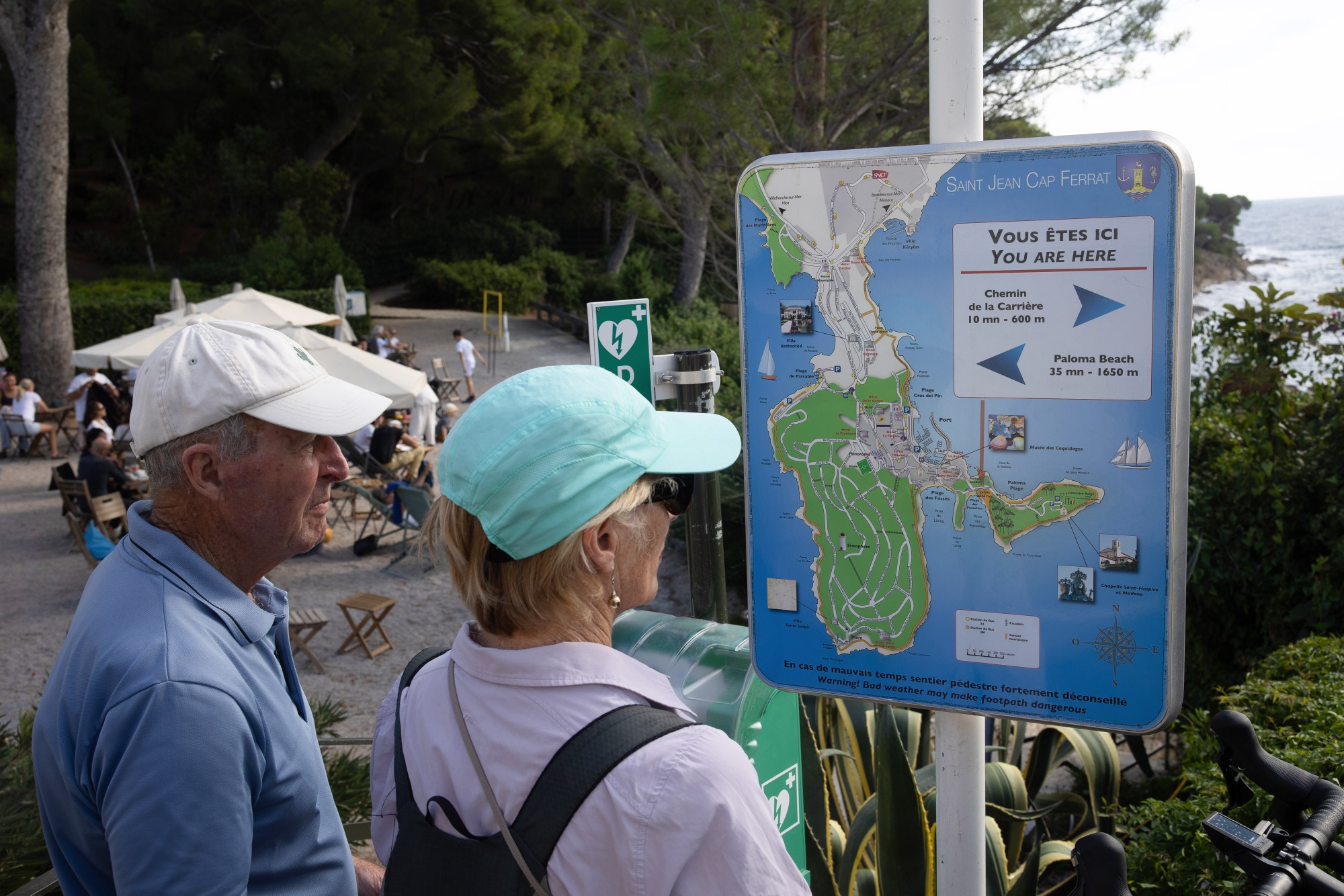 Visitors read a map of the peninsula in Saint-Jean-Cap-Ferrat, France, on Saturday, Oct. 21, 2023. Tucked between Monaco and Nice and jutting into the Mediterranean Sea, Saint-Jean-Cap-Ferrat has been dubbed the 
