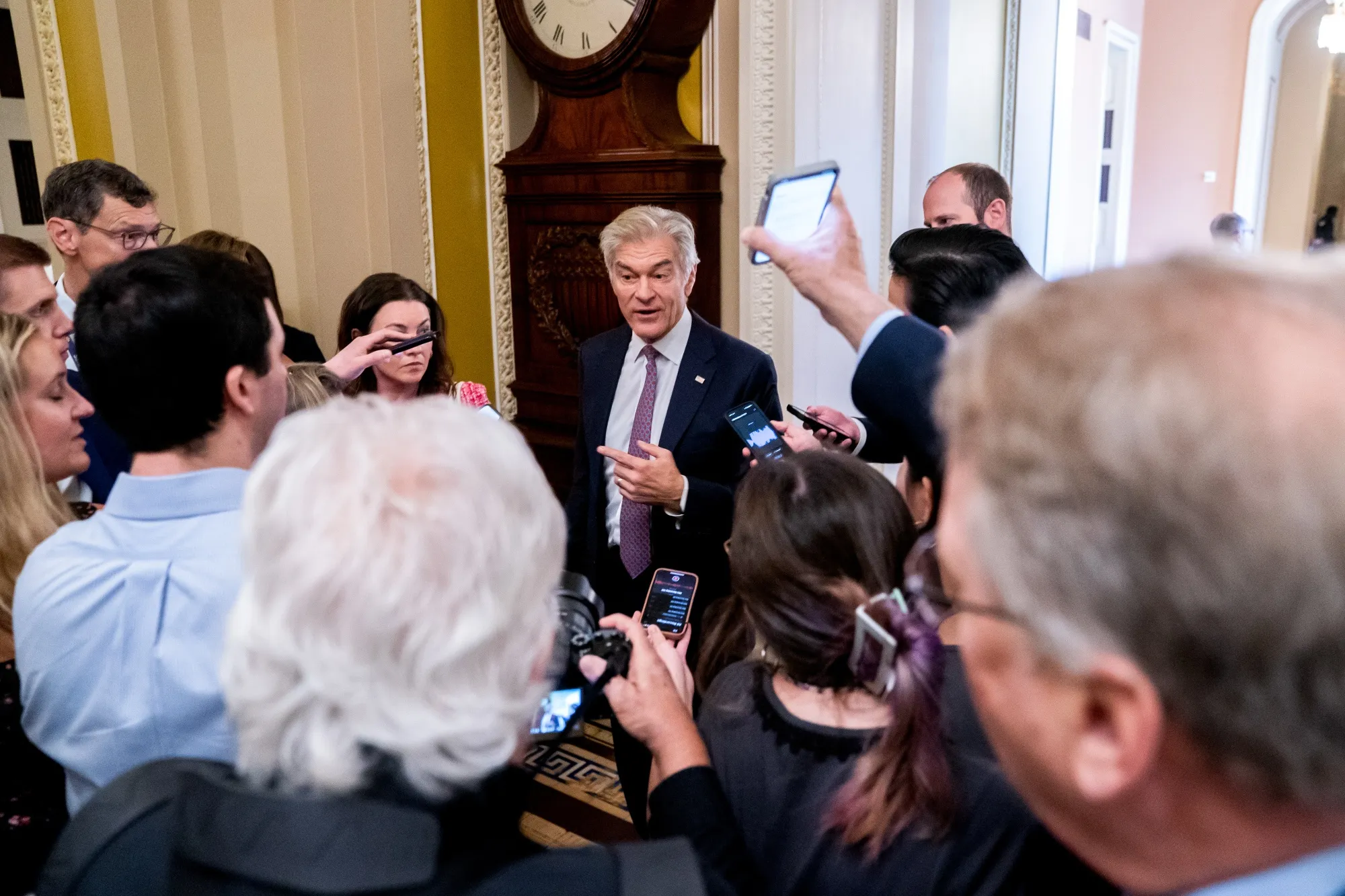 Mehmet Oz,&nbsp;center, speaks to members of the media&nbsp;at the US Capitol in Washington on June 4.