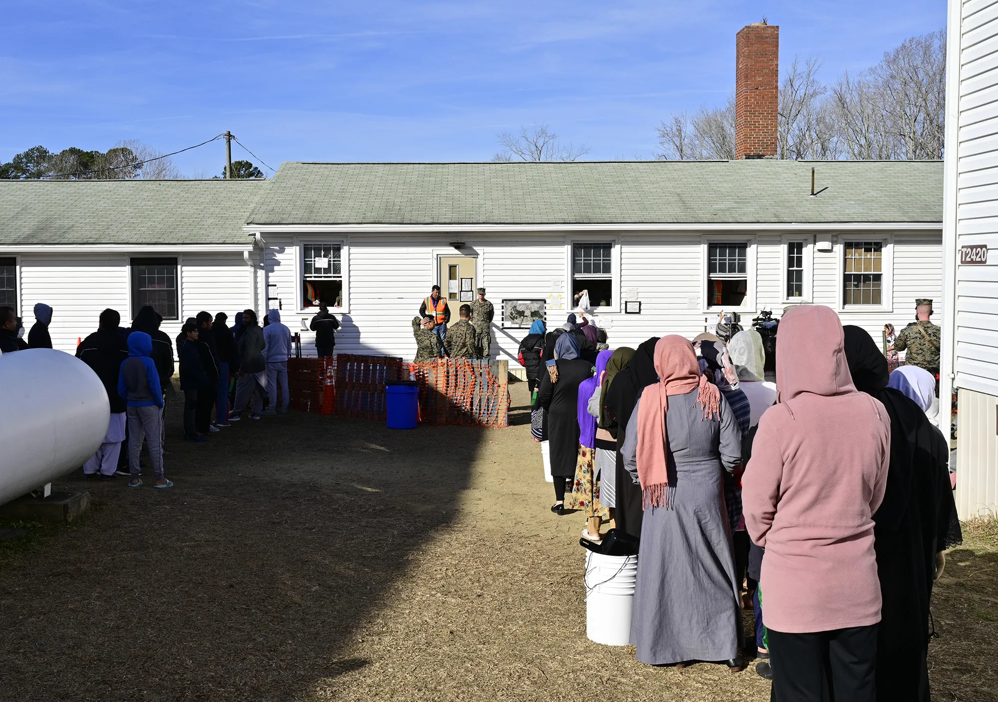 Afghans stand in line at a&nbsp;hygiene distribution center at Fort Pickett in Blackstone, Virginia in Dec.&nbsp;2021.