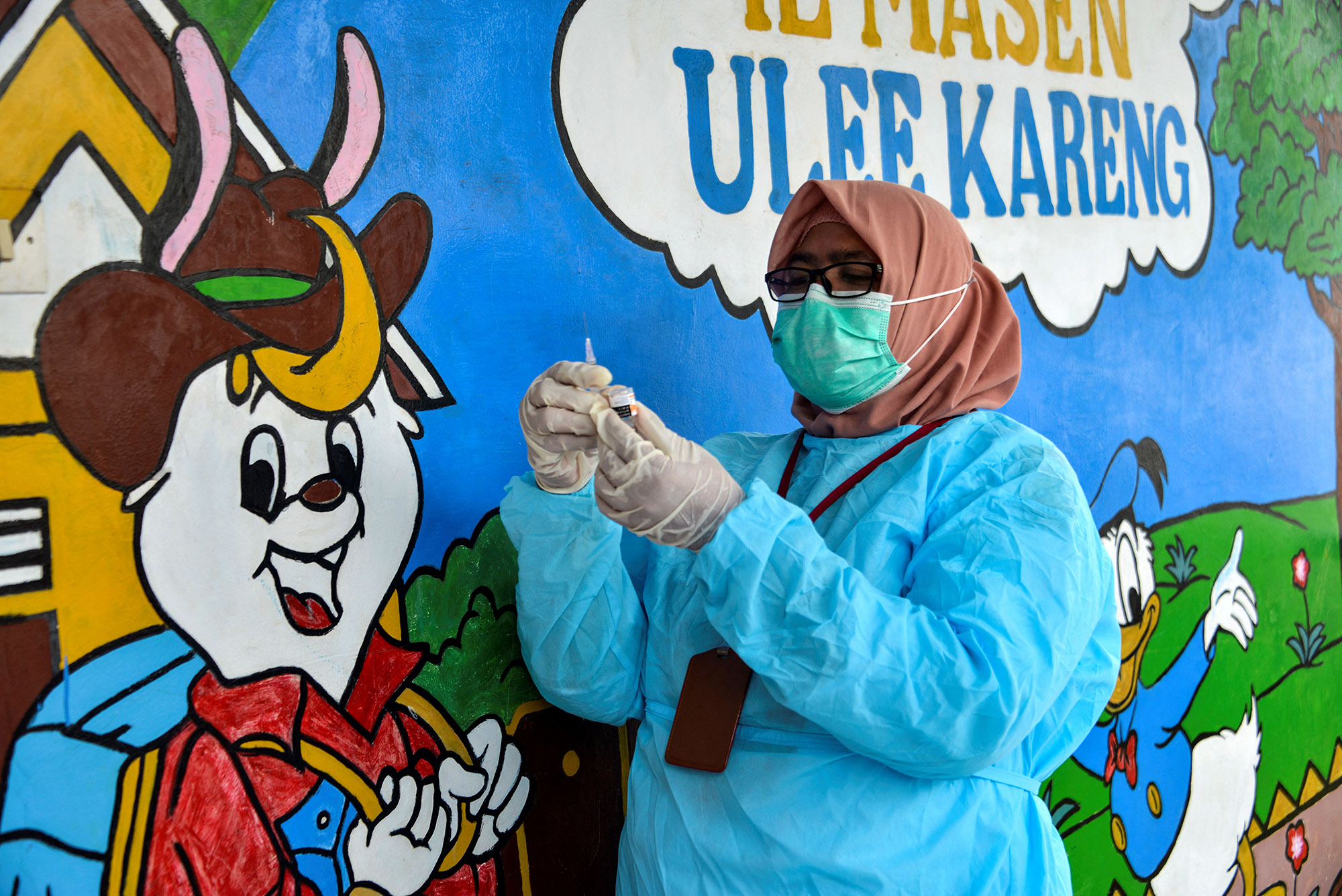 A health worker prepares a dose of the Sinovac vaccine at a community centre in Banda Aceh, Indonesia,&nbsp;on June 28.