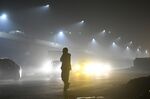 A pedestrian is silhouetted as traffic moves along a road shrouded in smog in New Delhi, India, on&nbsp;Nov. 10, 2017.&nbsp;