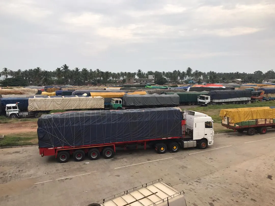 Trucks wait for permission to enter Nigeria at the border in Benin on Dec. 4, 2019.