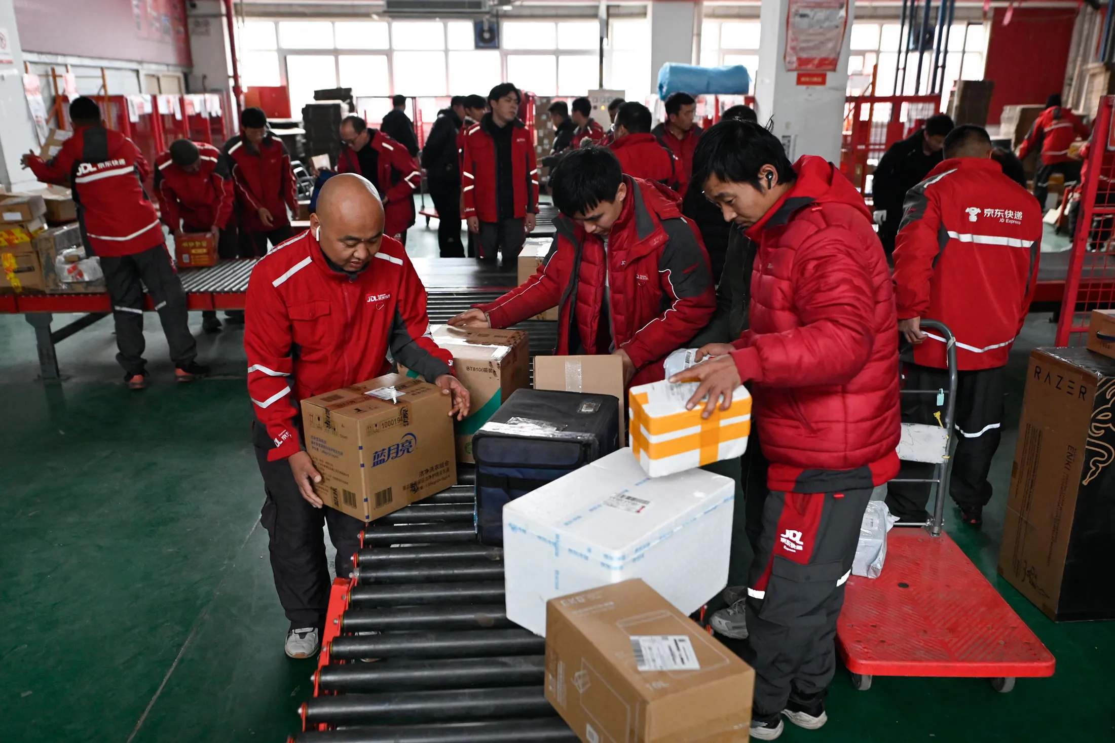 Workers sort packages for delivery at a JD.com warehouse in Beijing on Nov. 11.