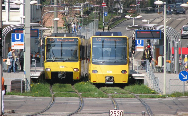 Two light rail trains wait for passengers in Stuttgart, Germany.