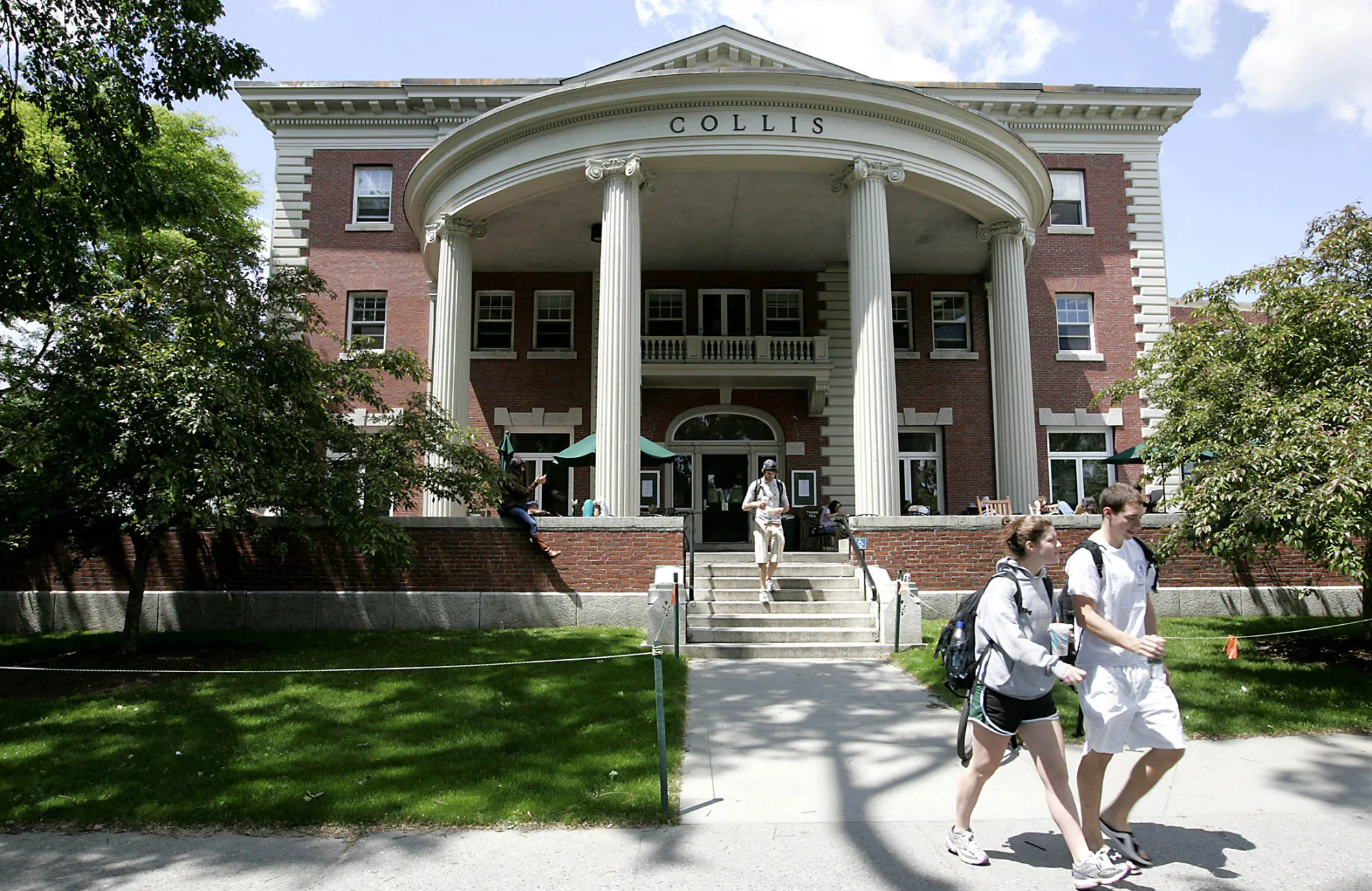 Students walk outside the Collis building on the campus of Dartmouth College.