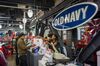 An employee hands a customer a shopping bag at an Old Navy Inc. store in San Francisco, California, U.S., on Friday, Dec. 12, 2014.