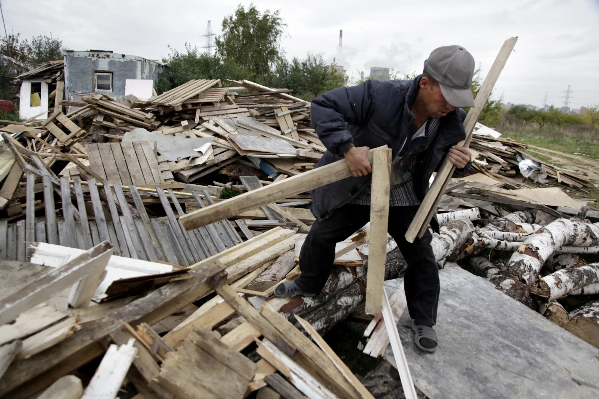 A Tajik migrant worker gathers wood in Moscow.