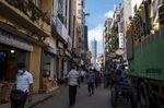 Pedestrians and workers pass stores in Colombo, Sri Lanka.