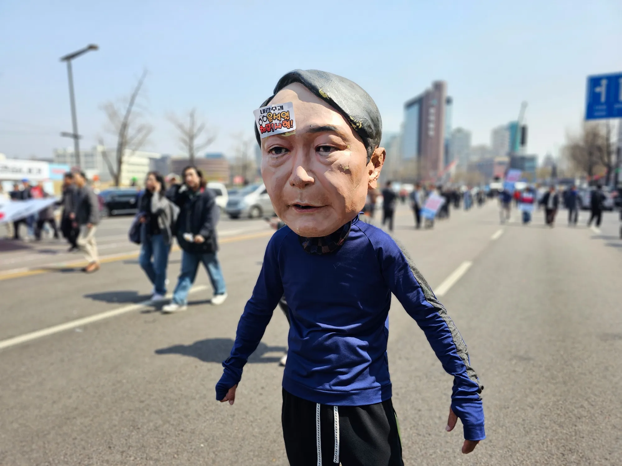 A person wearing a mask in the likeness of Yoon Suk Yeol at a protest in Seoul on April 4.