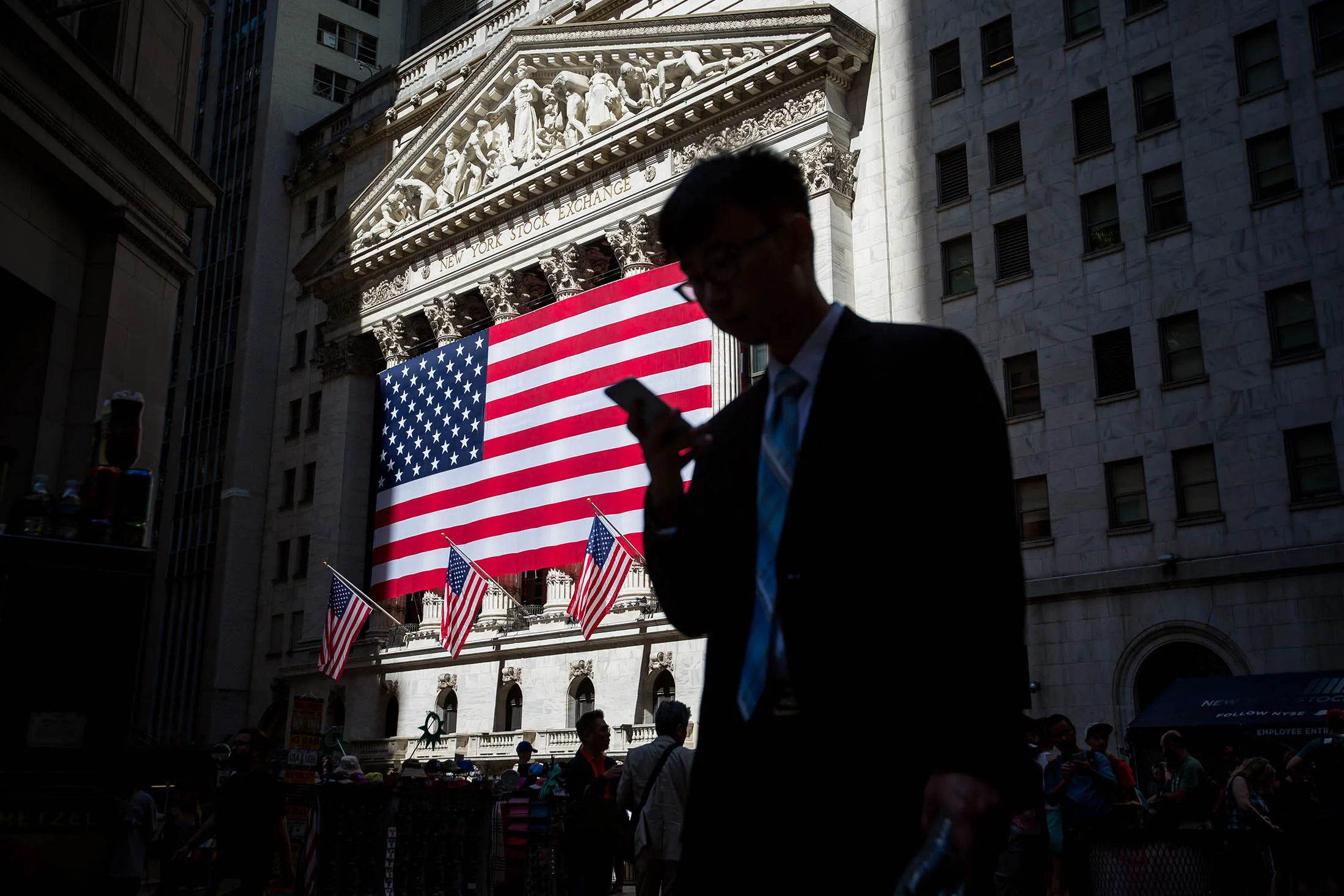 A pedestrian passes the New York Stock Exchange.
