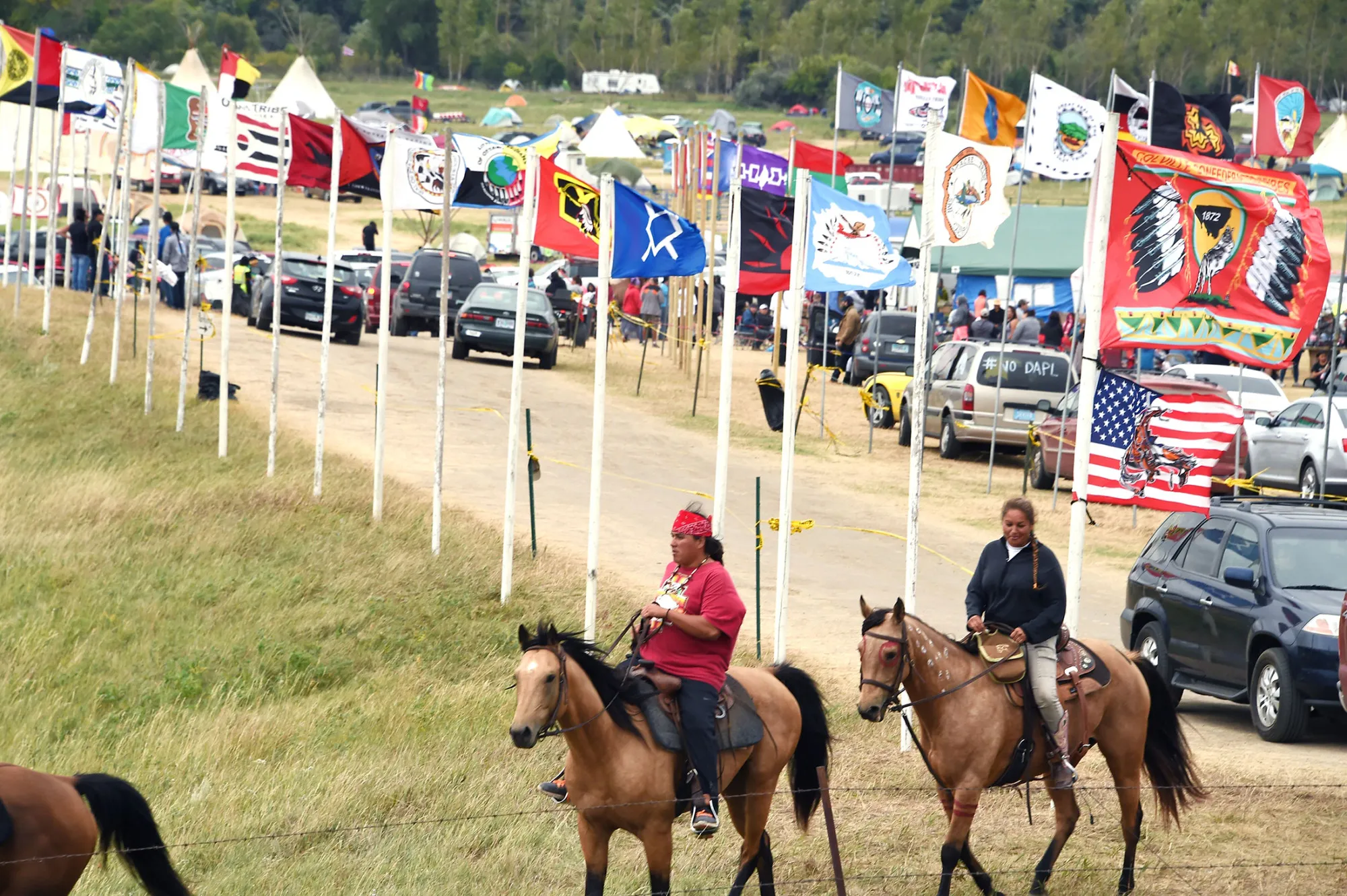 Flags of Native American tribes from across the US and Canada line the entrance to a protest encampment near Cannon Ball, North Dakota where members of the Standing Rock Sioux Tribe and their supporters have gather to voice their opposition to the Dakota Access Pipeline (DAPL) on Sept. 3, 2016.
