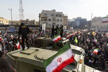 Security forces monitor a rally in Tehran on Jan. 12.