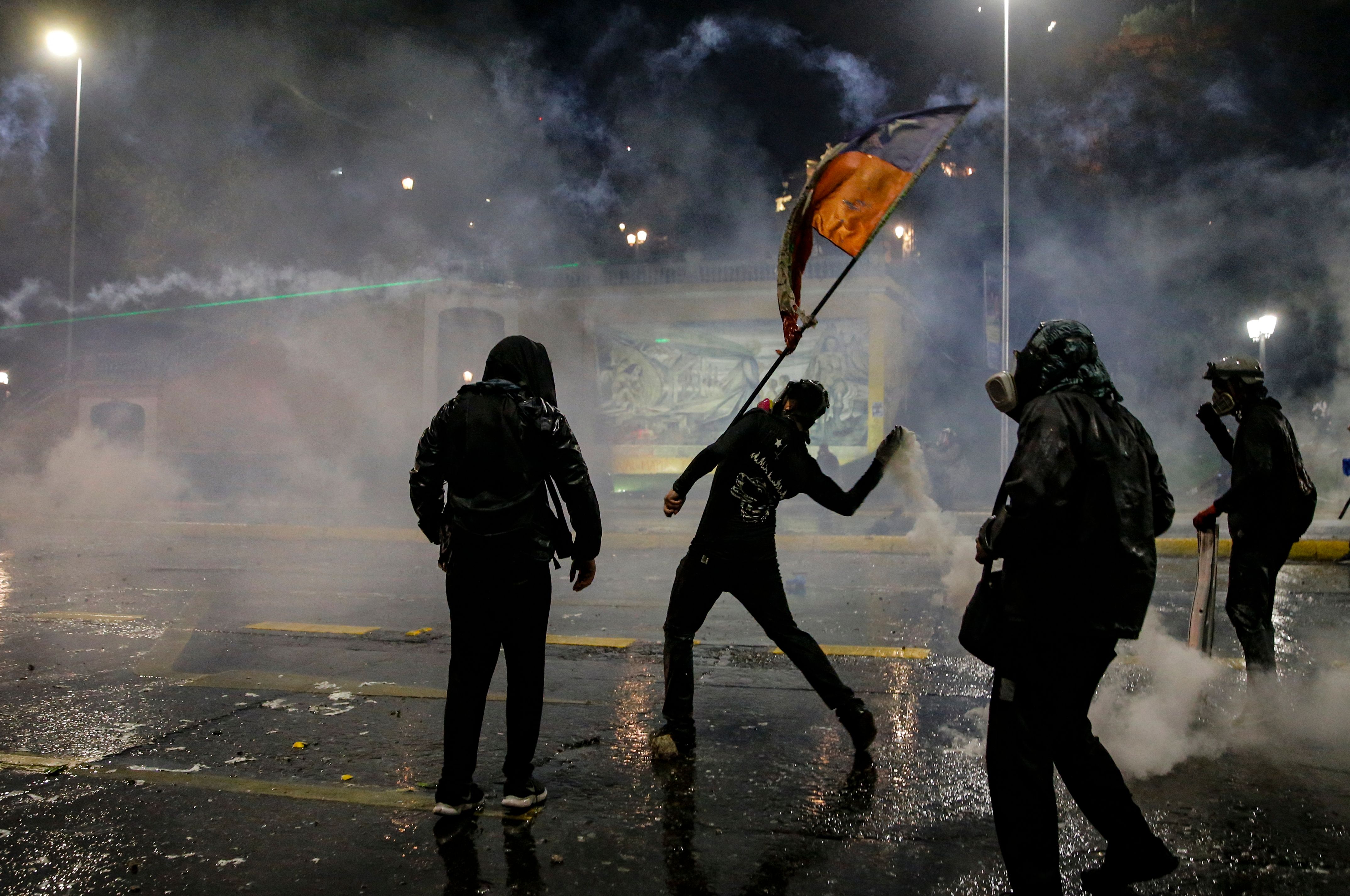Demonstrators clash with the police during a protest in Santiago, on Oct. 18.